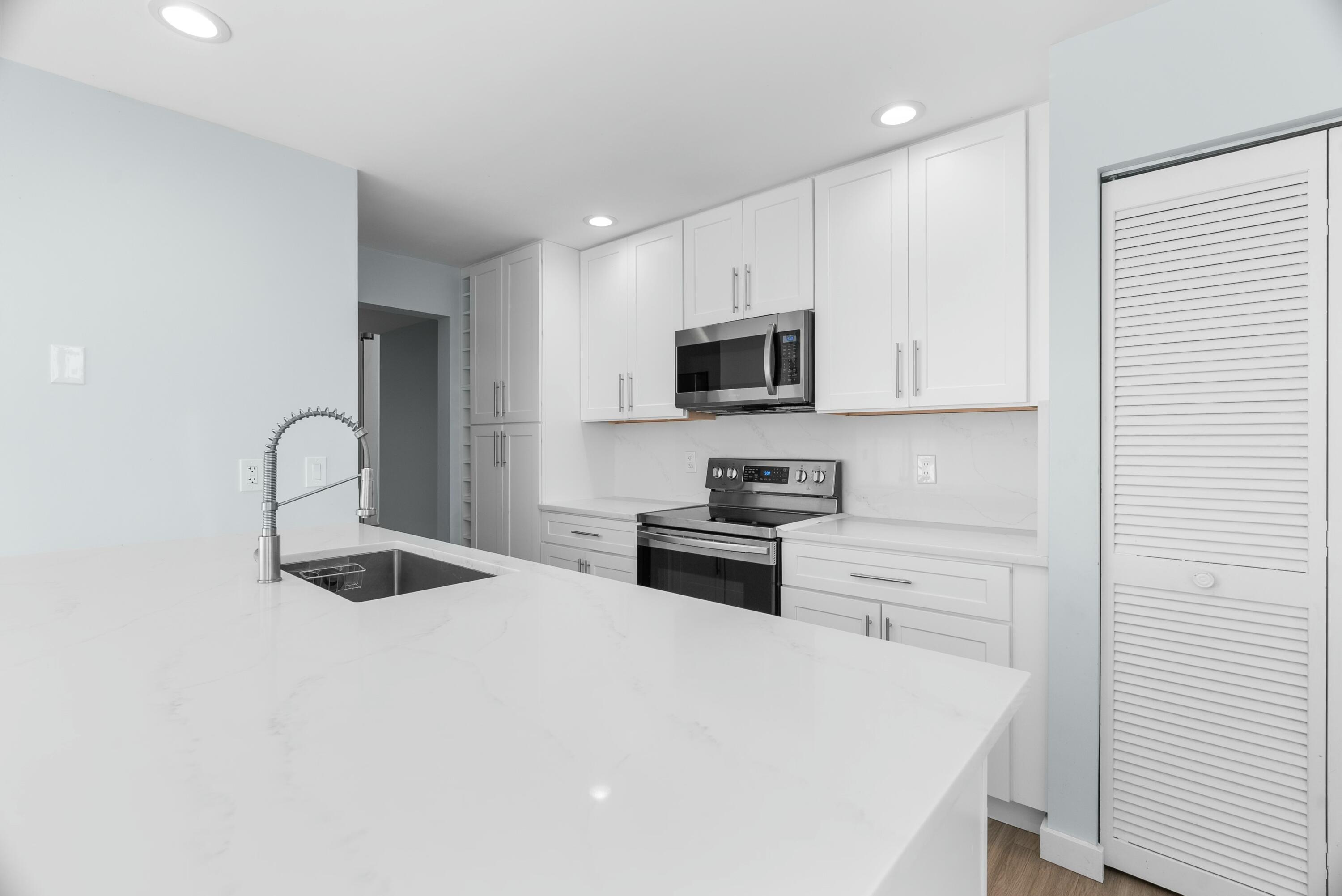 210 Ocean Dunes Circle Jupiter, FL 33477 - Photo 21 of 43 a kitchen with granite countertop a sink and appliances