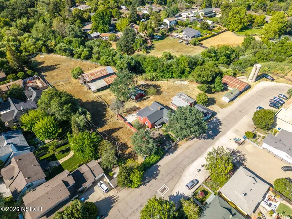 an aerial view of a house with a yard