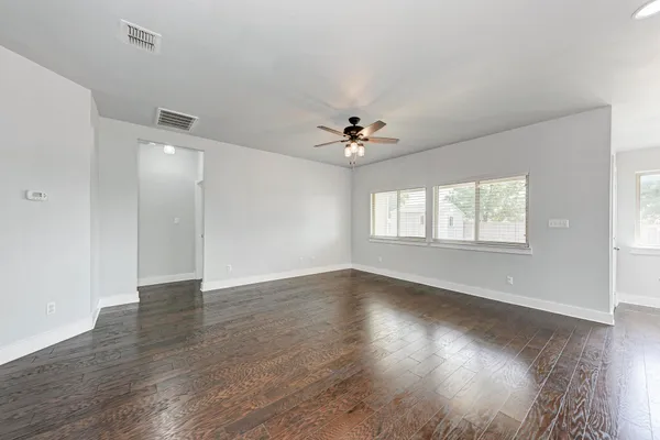 wooden floor in an empty room with a window