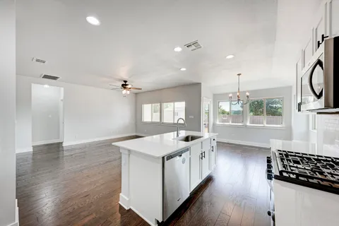 a very nice looking room with wooden floor and a window