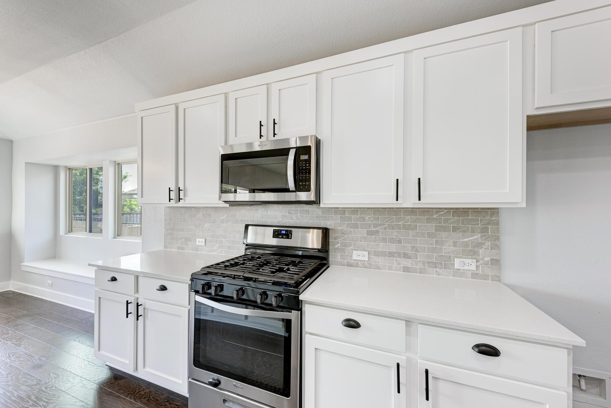 189 Tailwind Drive Kyle, TX 78640 - Photo 15 of 40 a kitchen with white cabinets and appliances