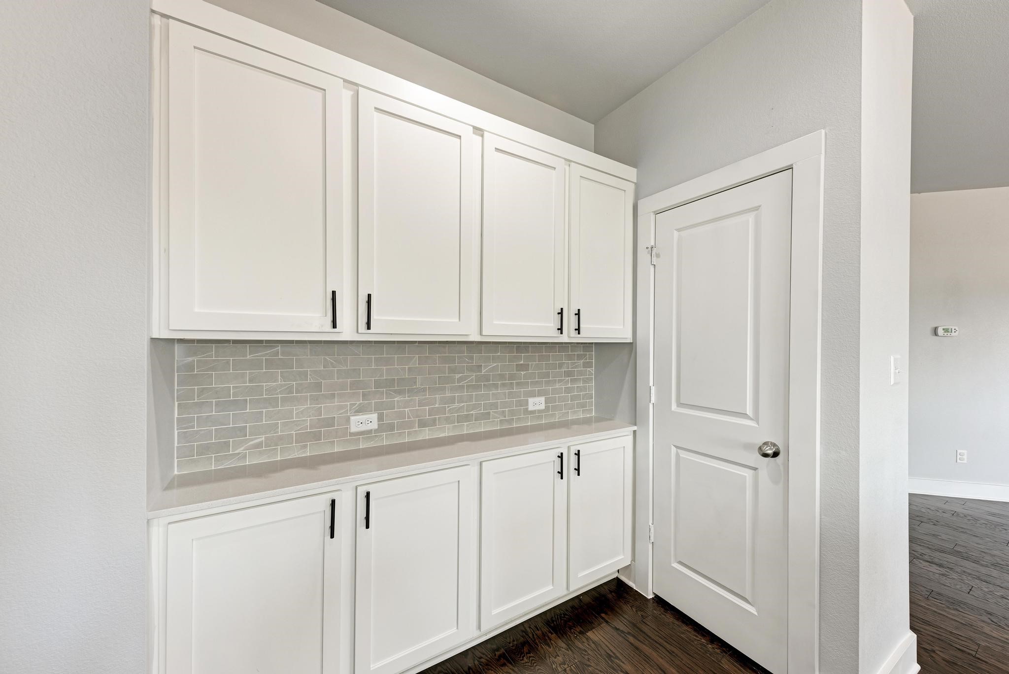 189 Tailwind Drive Kyle, TX 78640 - Photo 16 of 40 a kitchen with granite countertop white cabinets and sink