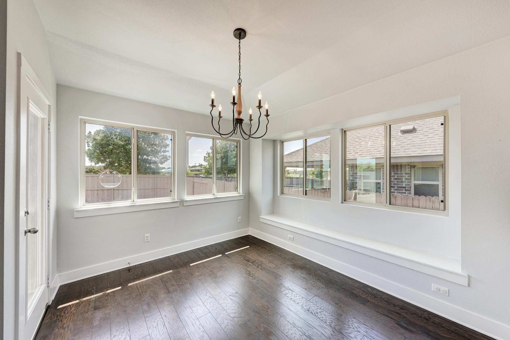 189 Tailwind Drive Kyle, TX 78640 - Photo 17 of 40 a view of an empty room with wooden floor and a window
