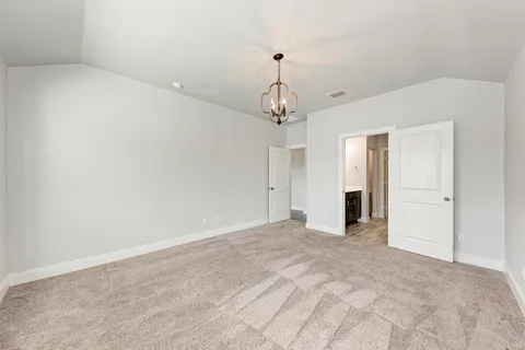 a view of an empty room with a chandelier