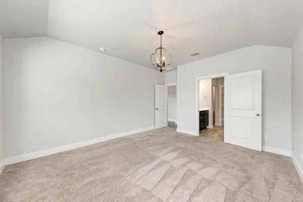 a view of an empty room with a chandelier