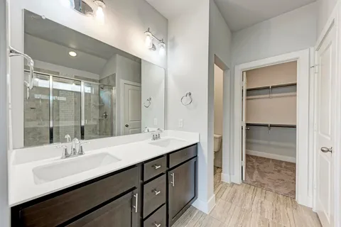 a bathroom with a sink double vanity and a mirror