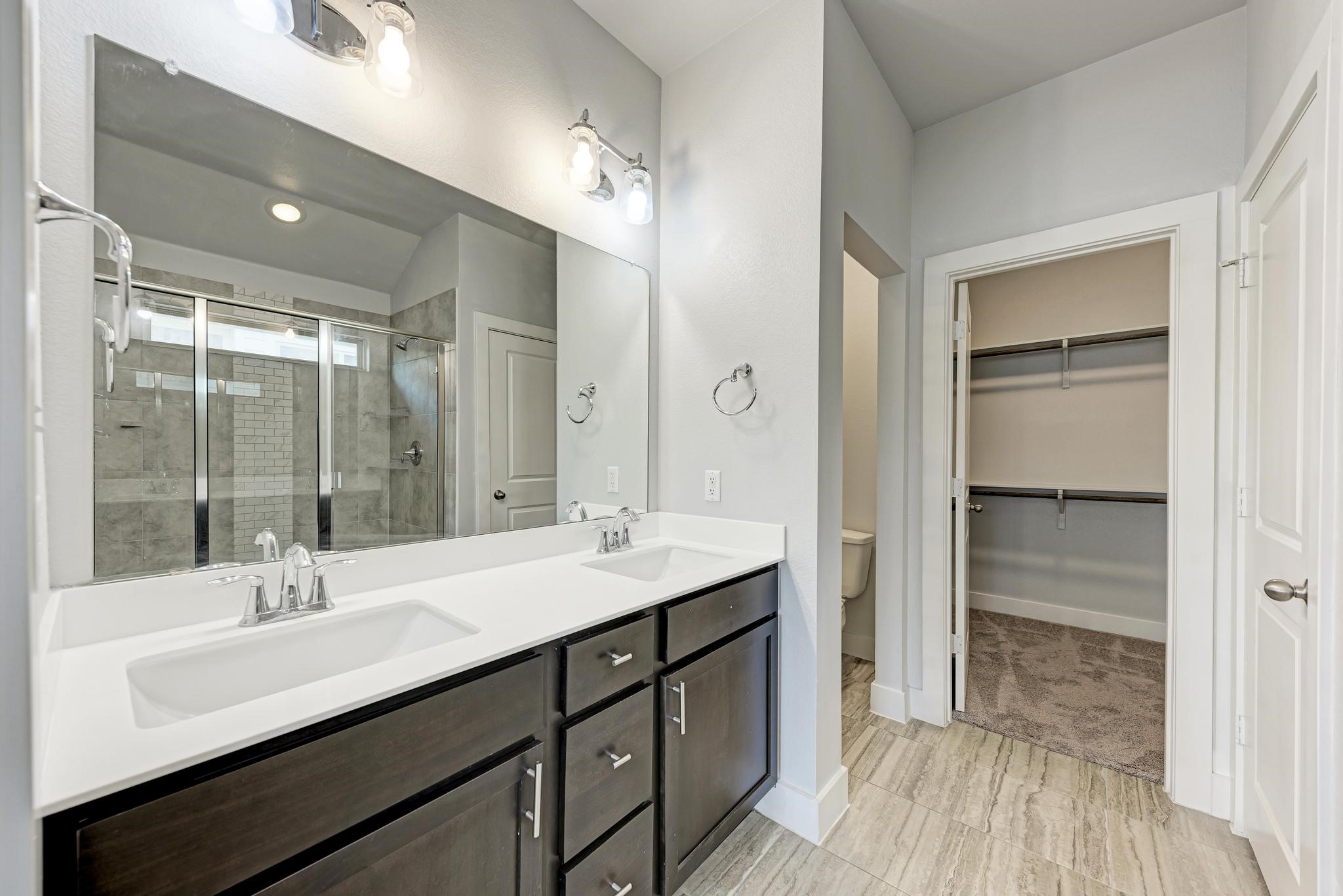 189 Tailwind Drive Kyle, TX 78640 - Photo 19 of 40 a bathroom with a sink double vanity and a mirror