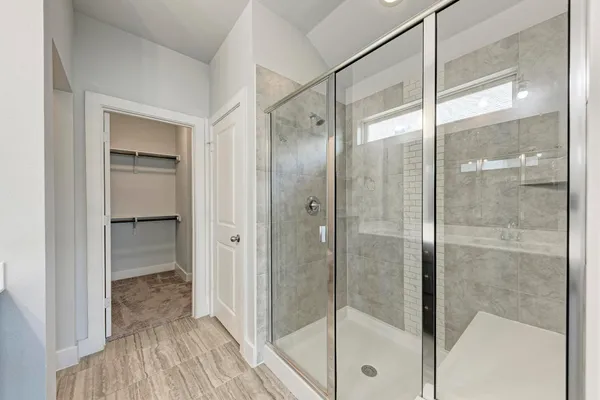 a bathroom with a glass shower door