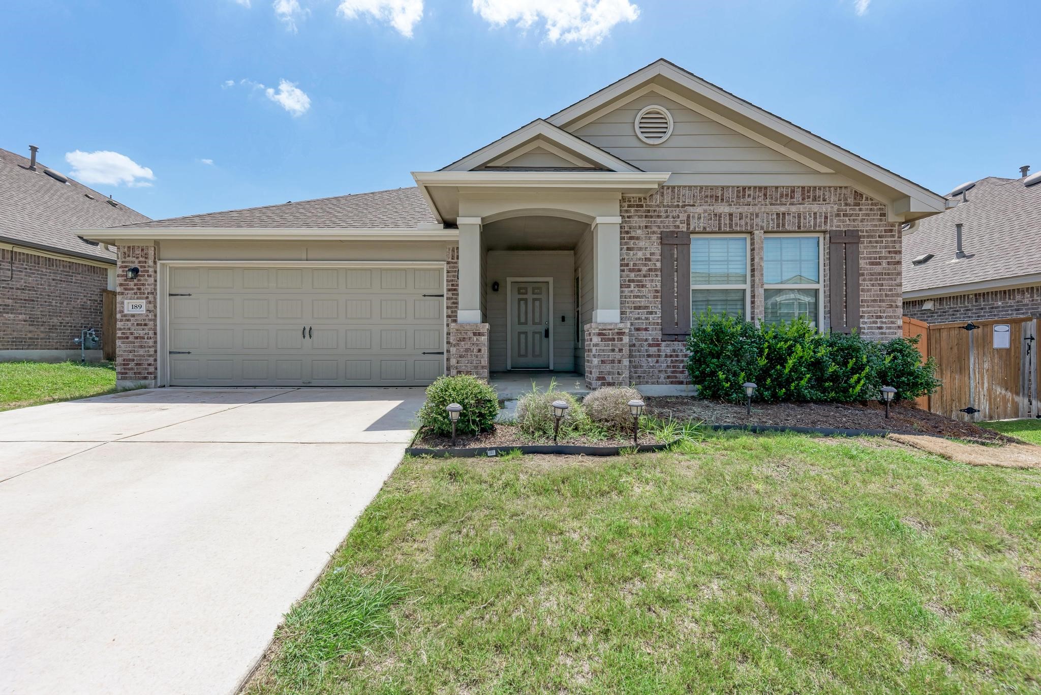 189 Tailwind Drive Kyle, TX 78640 - Photo 2 of 40 a front view of a house with garden