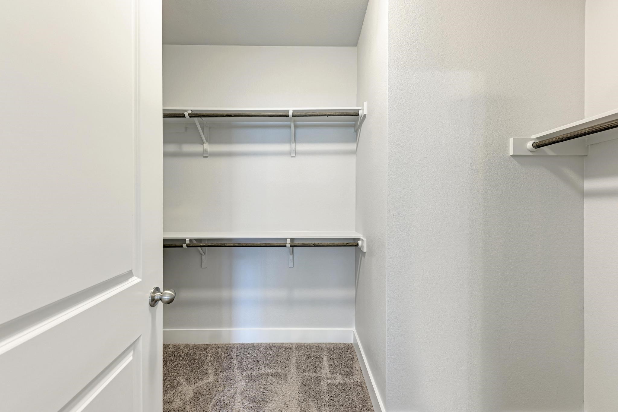 189 Tailwind Drive Kyle, TX 78640 - Photo 21 of 40 a close view of walk in closet with empty racks
