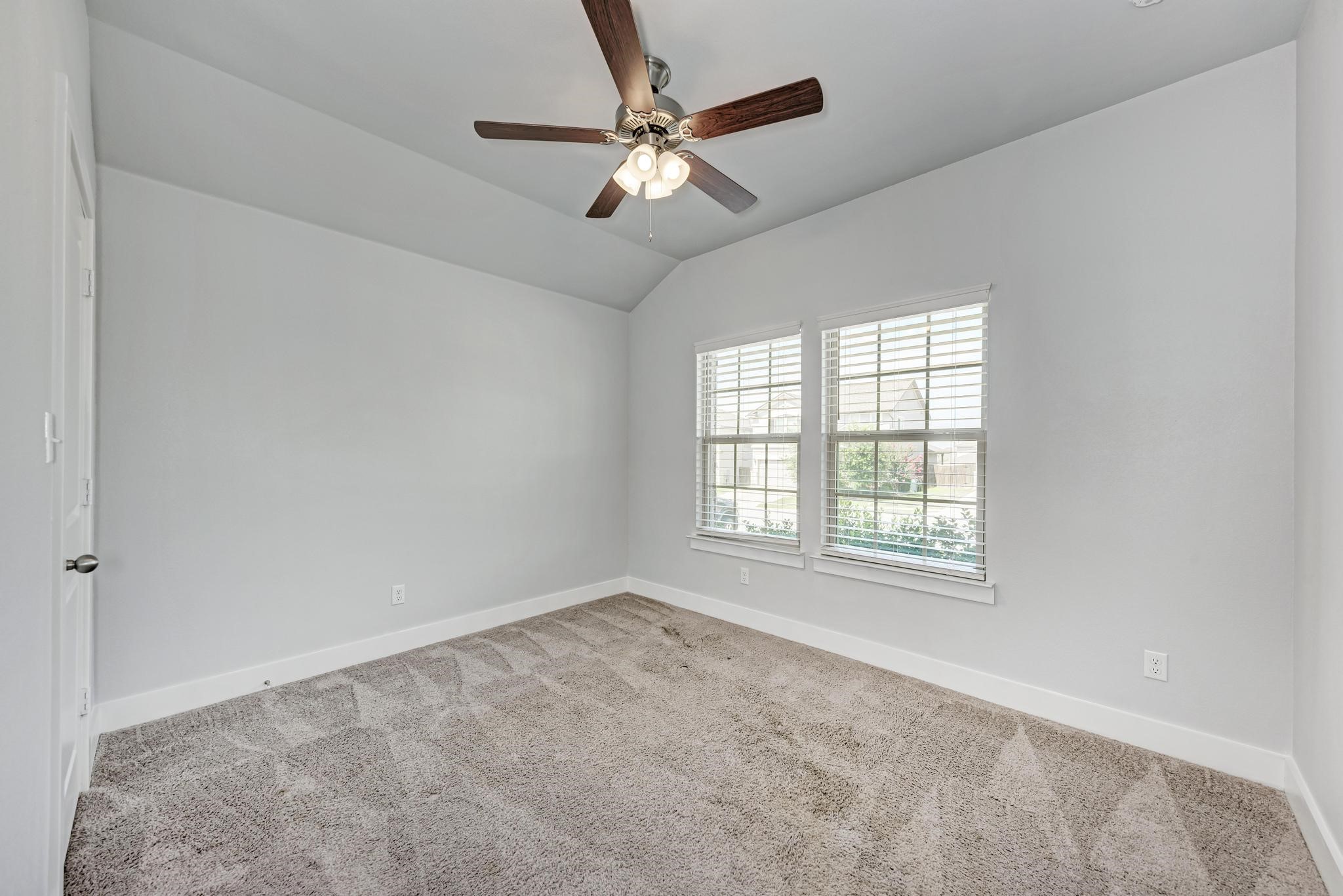 189 Tailwind Drive Kyle, TX 78640 - Photo 23 of 40 a view of an empty room with a window