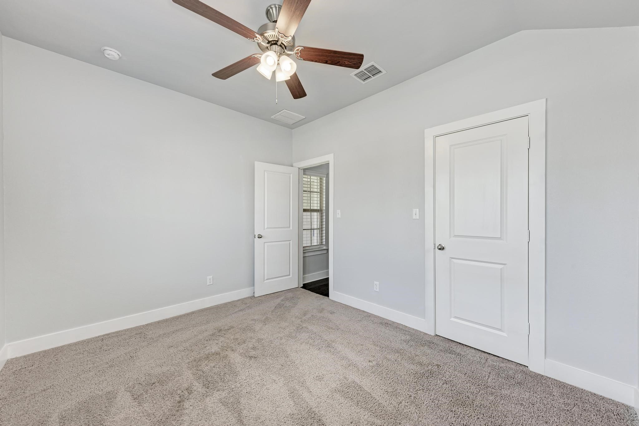 189 Tailwind Drive Kyle, TX 78640 - Photo 24 of 40 an empty room with closet and a ceiling fan
