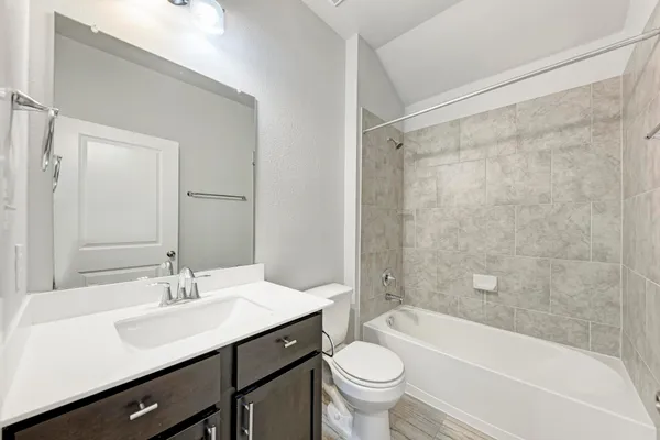 a bathroom with a sink a toilet and a bathtub