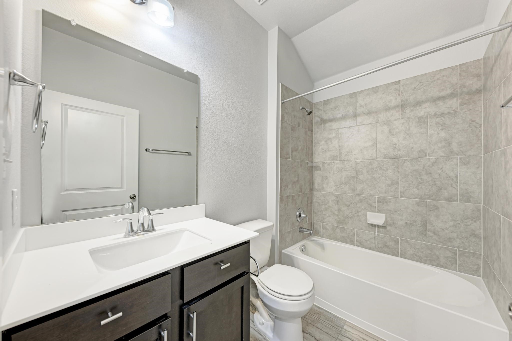 189 Tailwind Drive Kyle, TX 78640 - Photo 25 of 40 a bathroom with a sink a toilet and a bathtub