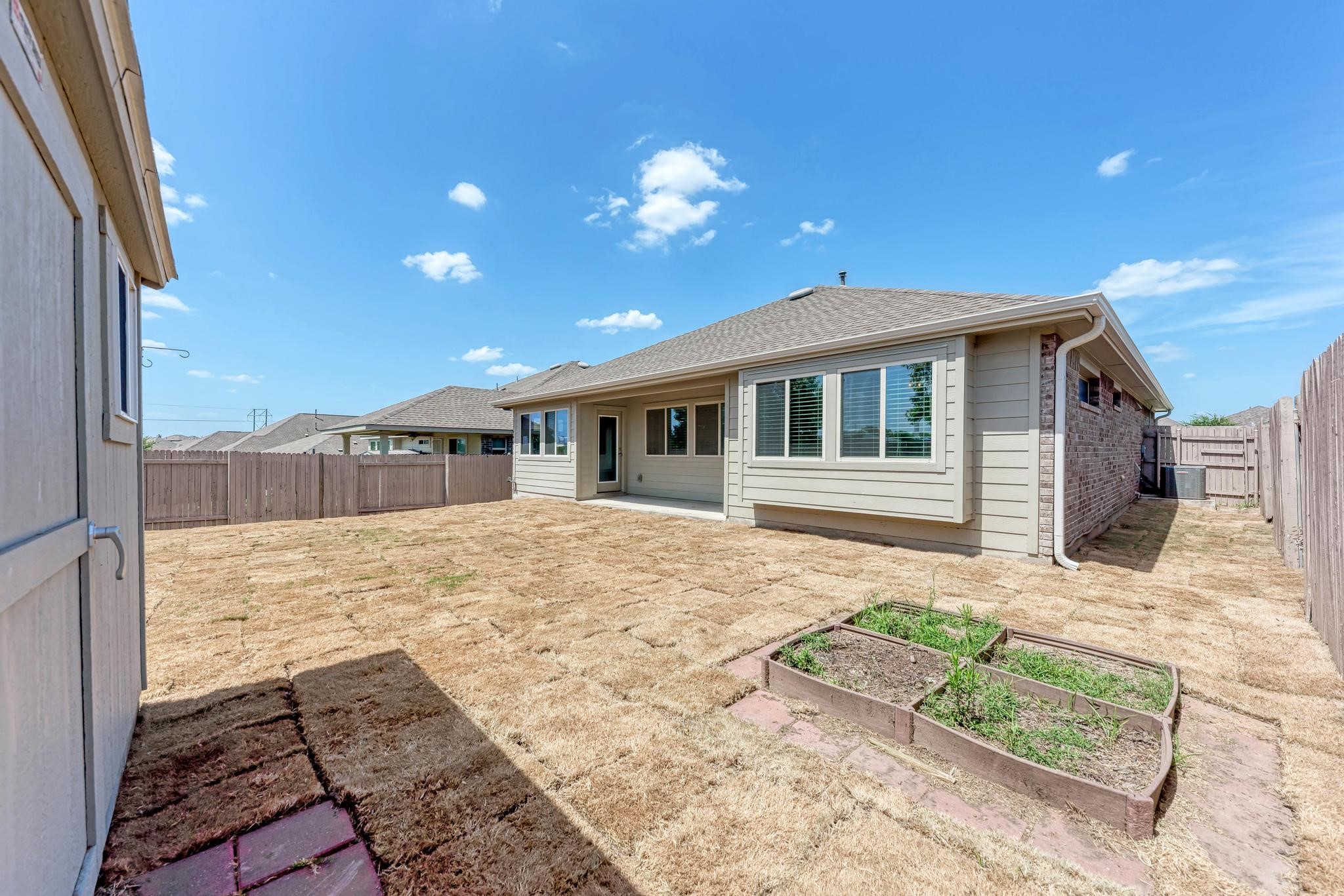 189 Tailwind Drive Kyle, TX 78640 - Photo 29 of 40 a front view of a house with a yard