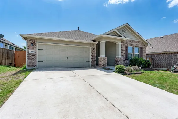 a front view of a house with a garden and pathway
