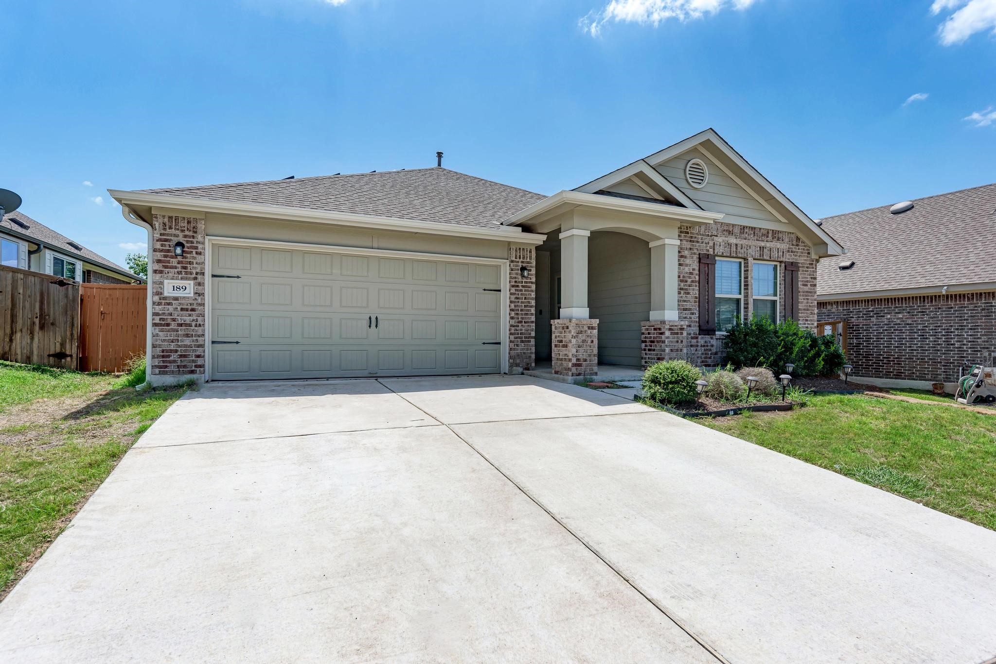 189 Tailwind Drive Kyle, TX 78640 - Photo 36 of 40 a front view of a house with a garden and pathway