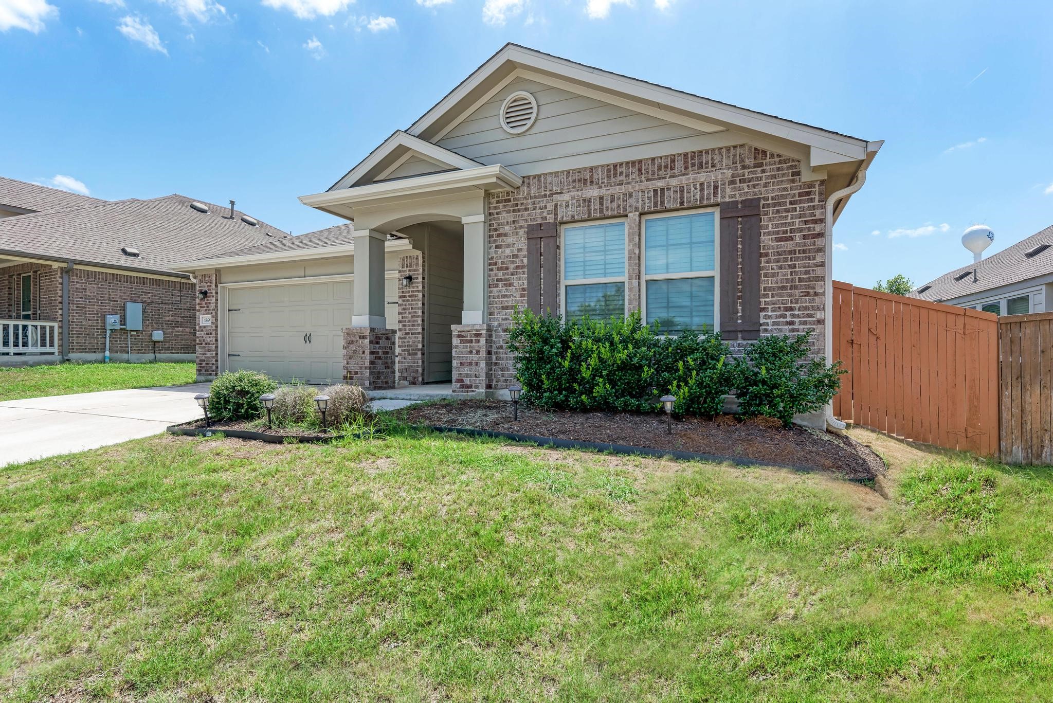 189 Tailwind Drive Kyle, TX 78640 - Photo 8 of 40 a front view of a house with garden