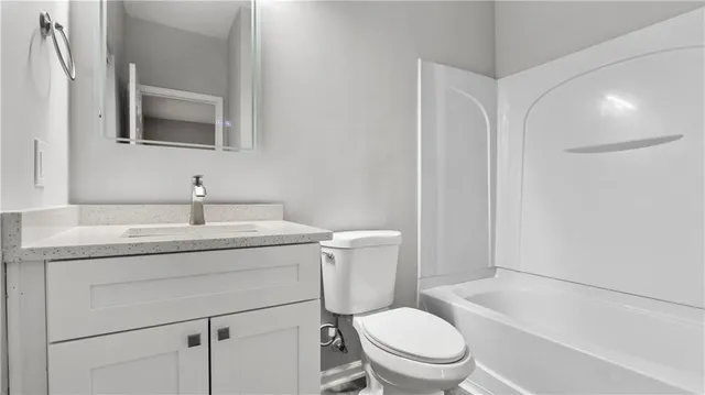 a bathroom with a sink vanity and a toilet