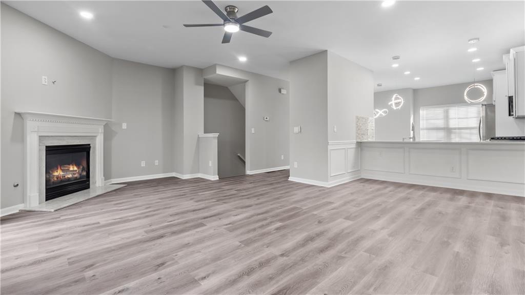 2793 Keystone Avenue Lithonia, GA 30058 - Photo 14 of 33 an empty room with wooden floor fireplace and cabinet