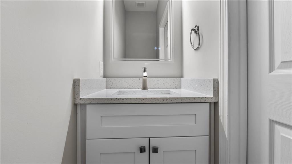 2793 Keystone Avenue Lithonia, GA 30058 - Photo 20 of 33 a bathroom with a granite countertop sink and a mirror