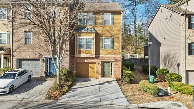 a view of a brick house with many windows