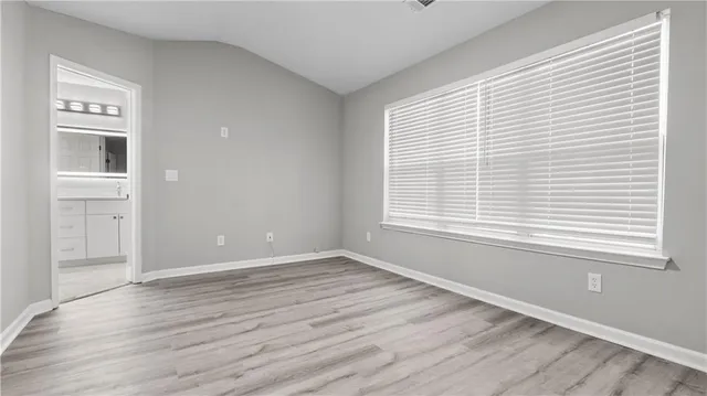 a view of an empty room and wooden floor