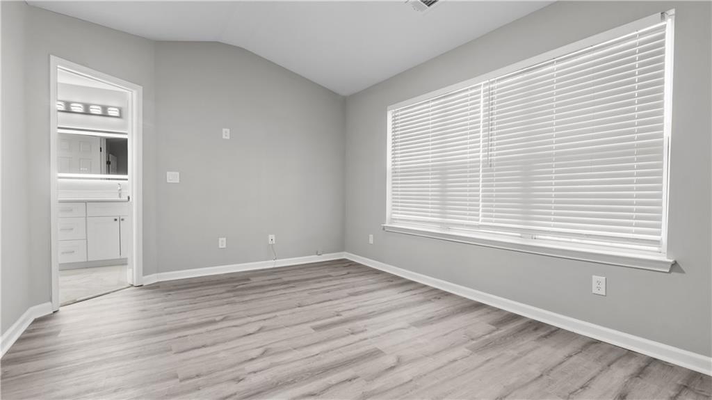 2793 Keystone Avenue Lithonia, GA 30058 - Photo 23 of 33 a view of an empty room with wooden floor and a window