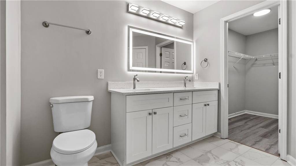 2793 Keystone Avenue Lithonia, GA 30058 - Photo 26 of 33 a bathroom with a toilet sink and mirror