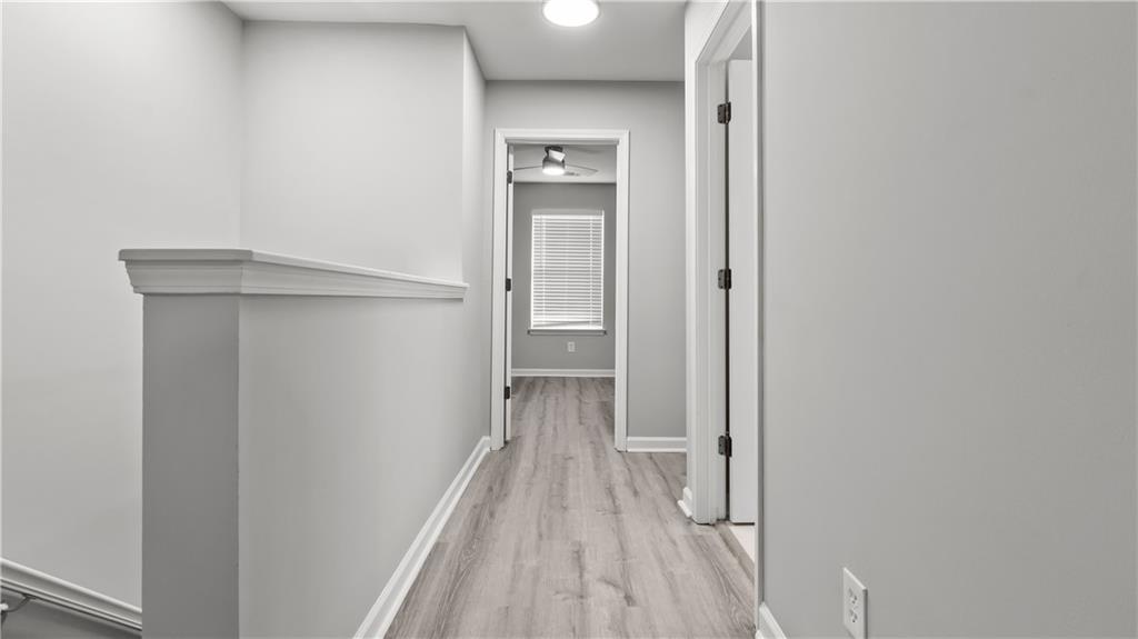2793 Keystone Avenue Lithonia, GA 30058 - Photo 28 of 33 a view of a hallway with wooden floor and a bathroom