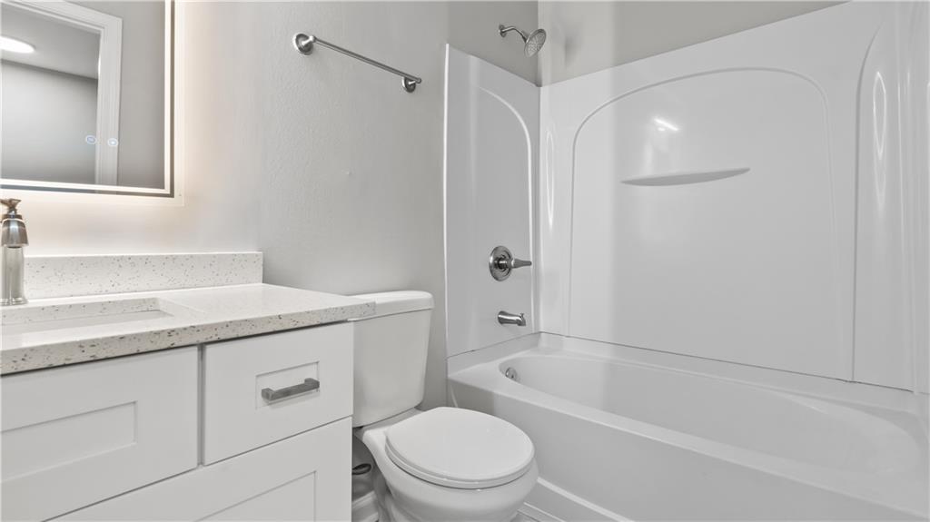 2793 Keystone Avenue Lithonia, GA 30058 - Photo 29 of 33 a bathroom with a sink a toilet and shower