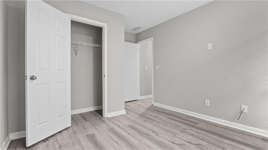 2793 Keystone Avenue Lithonia, GA 30058 - Photo 32 of 33 a view of an empty room with wooden floor and closet