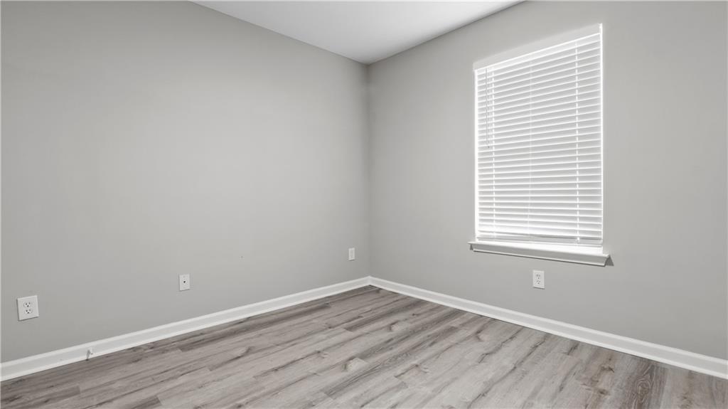 2793 Keystone Avenue Lithonia, GA 30058 - Photo 33 of 33 an empty room with wooden floor and a window