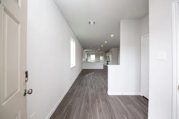 a view of hallway with wooden floor