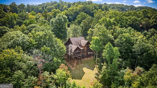 a living room with furniture a ceiling fan and a large window