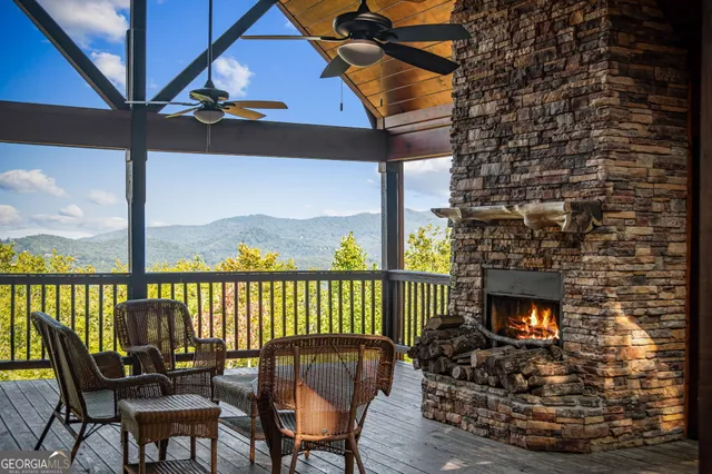 an aerial view of houses with deck and outdoor seating