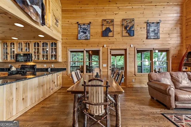 a large room with stainless steel appliances wooden cabinets and a stove