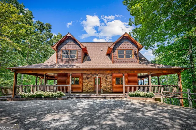 a dining room with furniture a chandelier and wooden floor