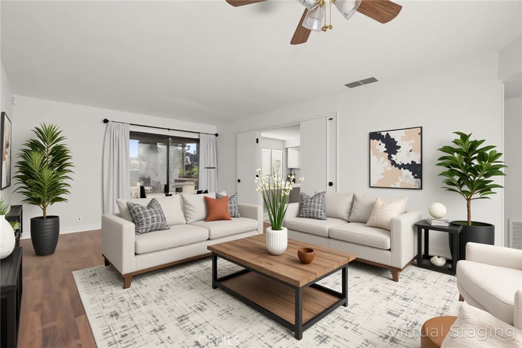 a living room with furniture or couch and a potted plant