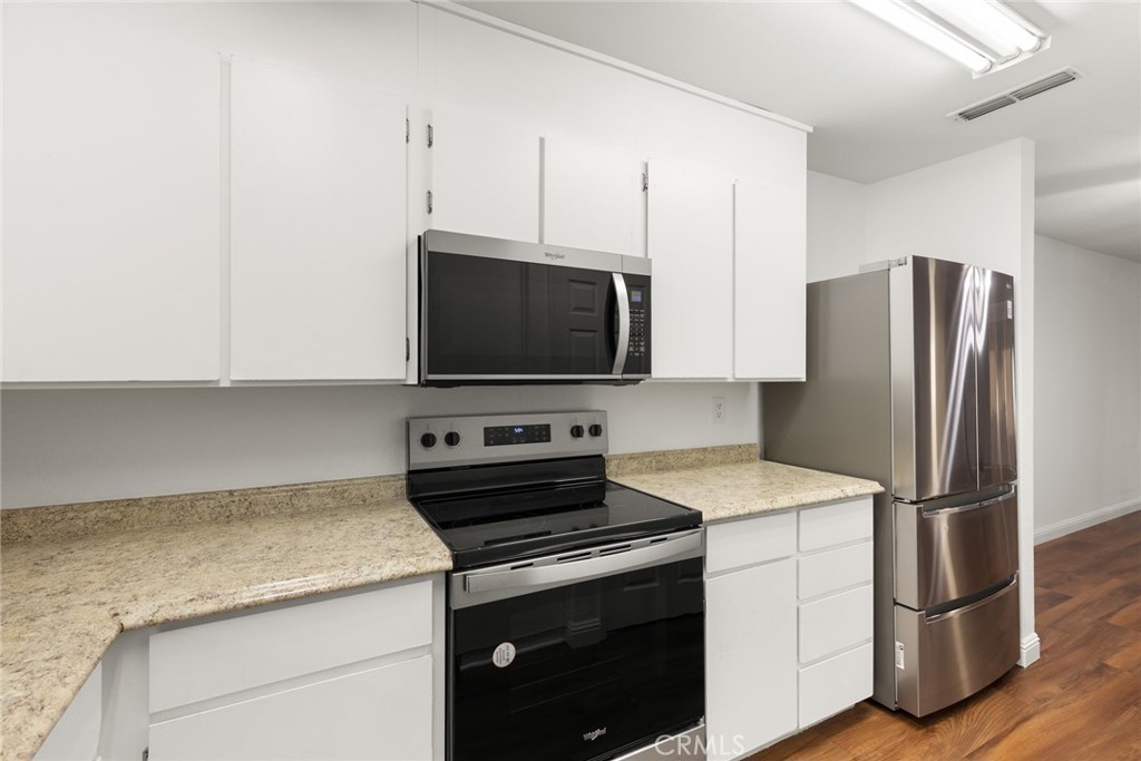 1420 Sherman Avenue, Unit 27 Chico, CA 95926 - Photo 14 of 29 a kitchen with stainless steel appliances a refrigerator stove and microwave