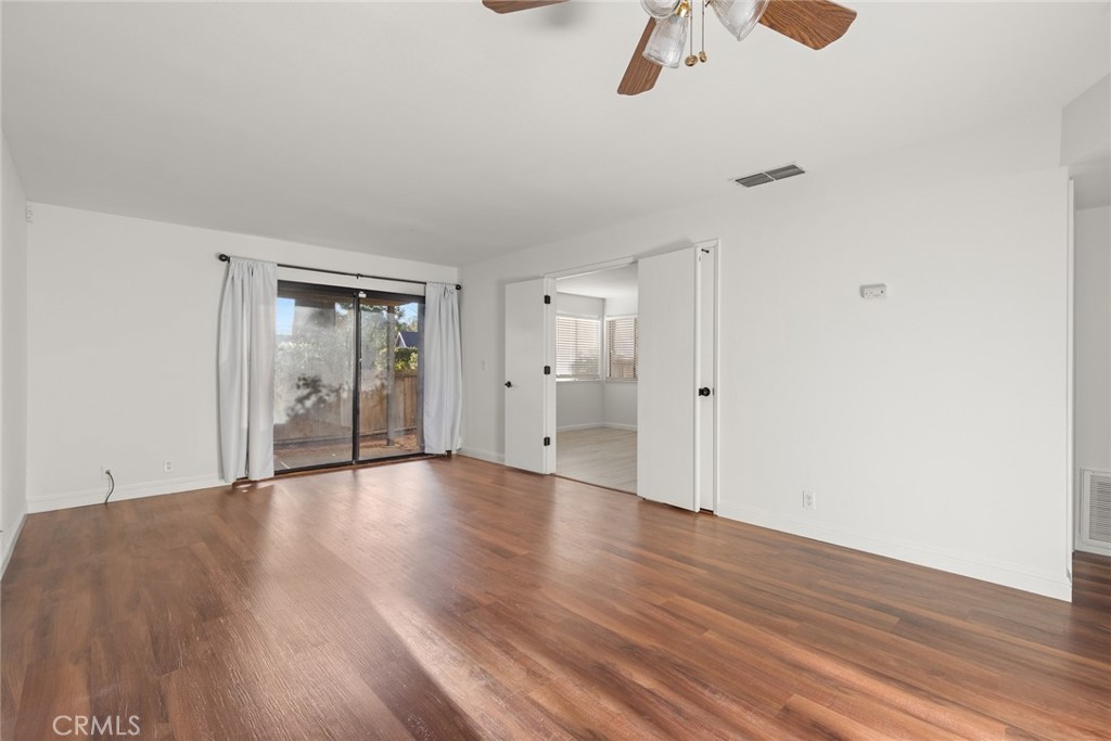 1420 Sherman Avenue, Unit 27 Chico, CA 95926 - Photo 17 of 29 a view of an empty room with wooden floor and windows