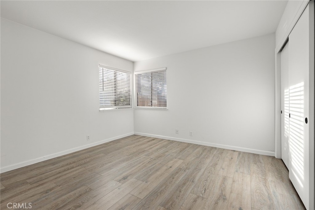 1420 Sherman Avenue, Unit 27 Chico, CA 95926 - Photo 20 of 29 an empty room with wooden floor and windows