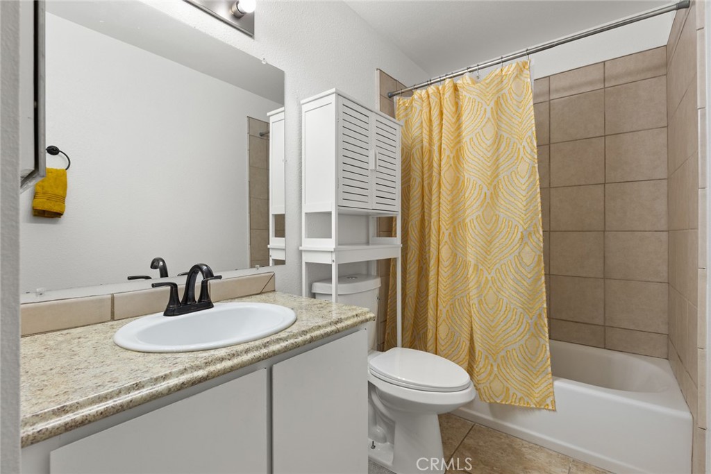 1420 Sherman Avenue, Unit 27 Chico, CA 95926 - Photo 26 of 29 a bathroom with a granite countertop sink and a mirror