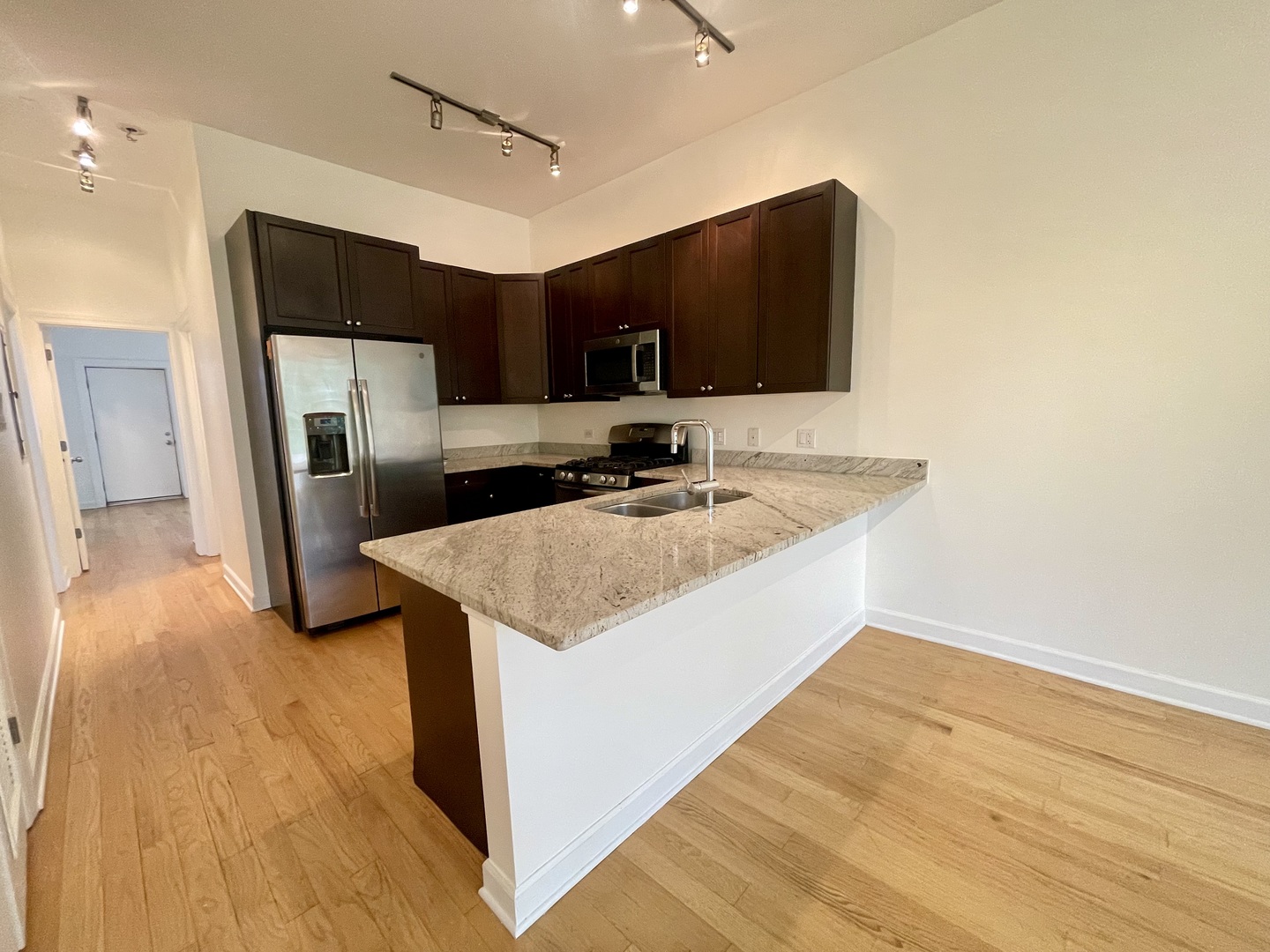 1746 West Division Street, Unit 3 Chicago, IL 60622 - Photo 12 of 20 a kitchen with stainless steel appliances granite countertop a sink and a microwave