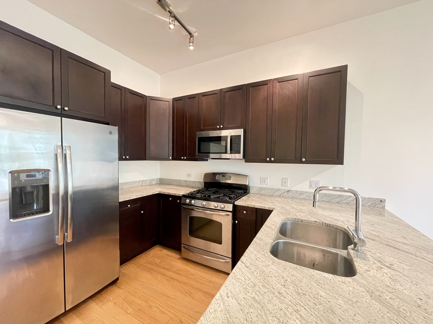 1746 West Division Street, Unit 3 Chicago, IL 60622 - Photo 13 of 20 a kitchen with granite countertop a refrigerator and a sink