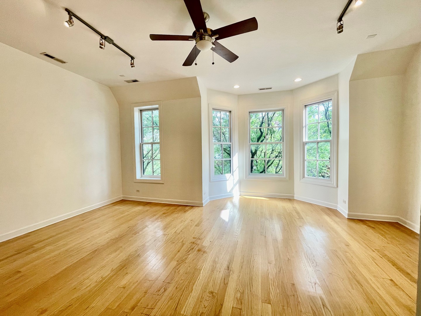 1746 West Division Street, Unit 3 Chicago, IL 60622 - Photo 8 of 20 a view of an empty room with window wooden floor and a kitchen view