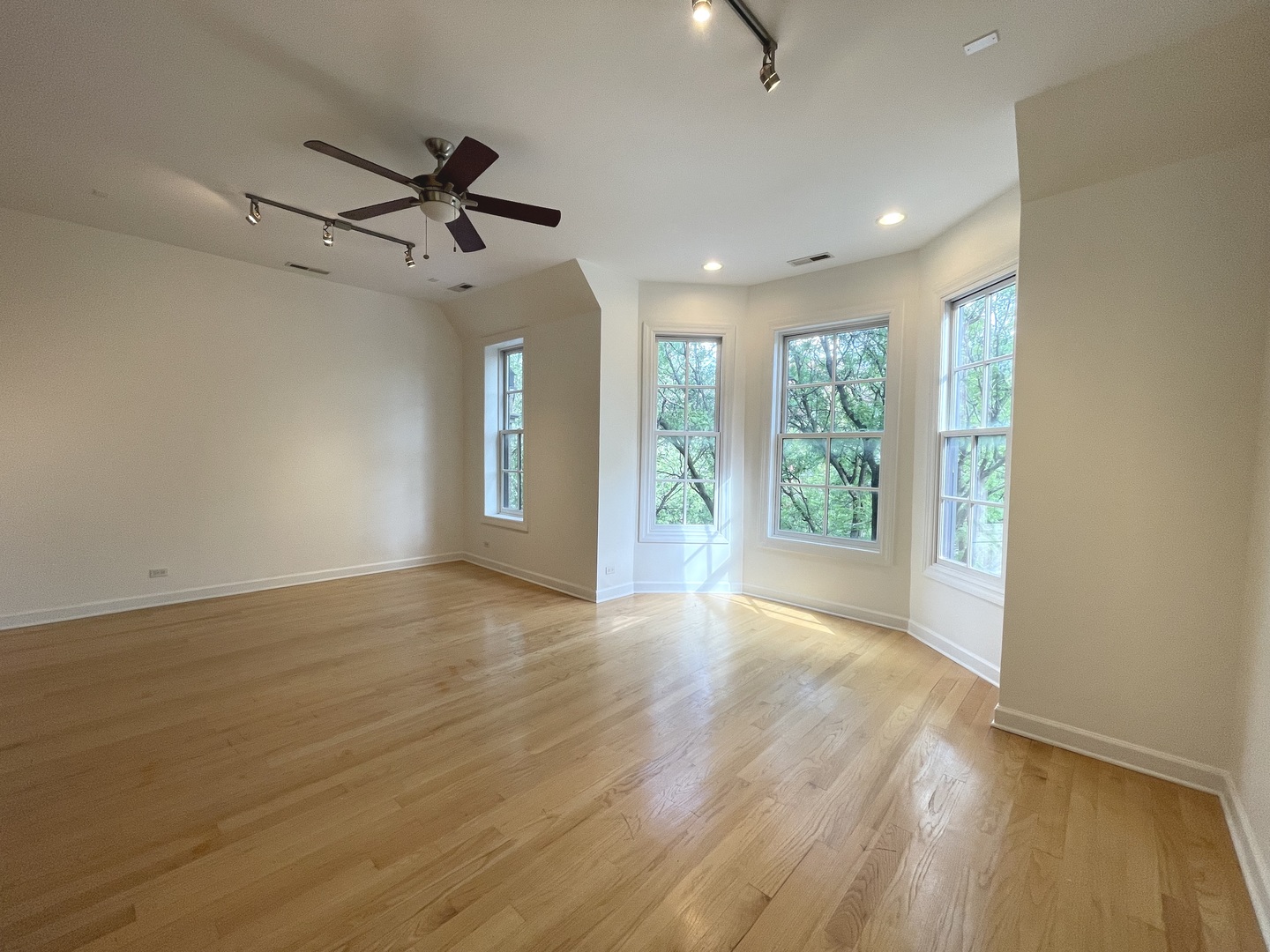 1746 West Division Street, Unit 3 Chicago, IL 60622 - Photo 9 of 20 a view of an empty room with wooden floor ceiling fan