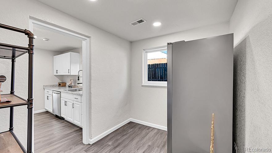 3984 Cook Street Denver, CO 80205 - Photo 11 of 34 a room with white cabinets and wooden floor