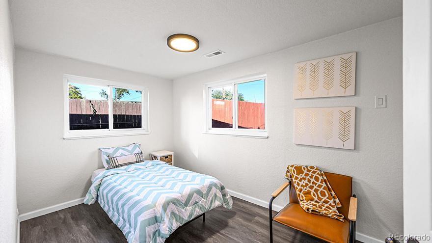 3984 Cook Street Denver, CO 80205 - Photo 12 of 34 a bedroom with a bed and wooden floor