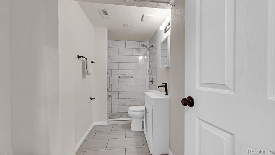 3984 Cook Street Denver, CO 80205 - Photo 15 of 34 a bathroom with a toilet and a shower